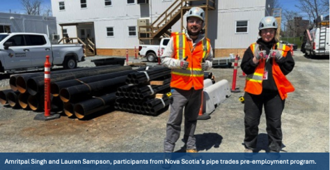 Two participants in the pipes trade program stand on the Halifax Infirmary construction site