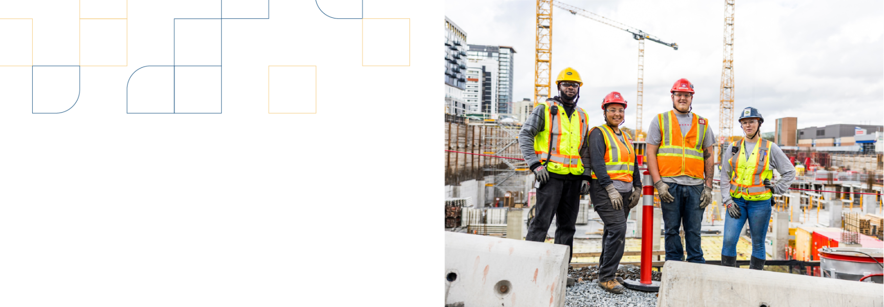 A group of apprentices poses in front of a job site.